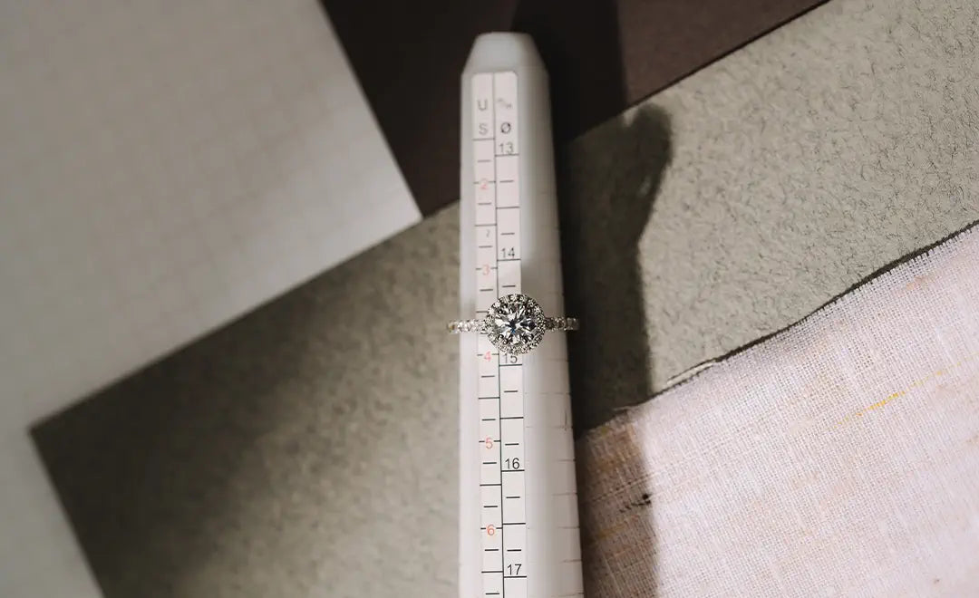18k white gold ring with diamonds on a ruler for size measurement