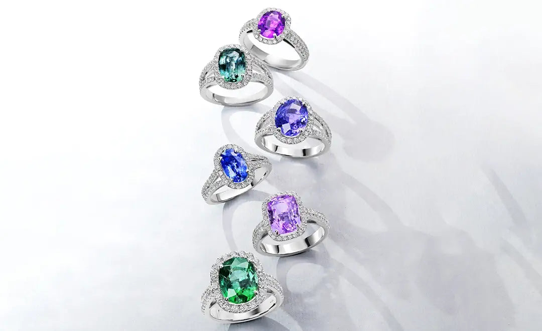 Set of 18k white gold rings with color gemstones on a white background